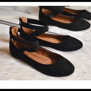 Black Bella Marie ballerina flats with ankle straps.